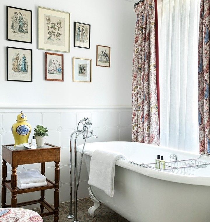 French Country Bathroom with Wood Side Table and White Tub via @airellesgordes