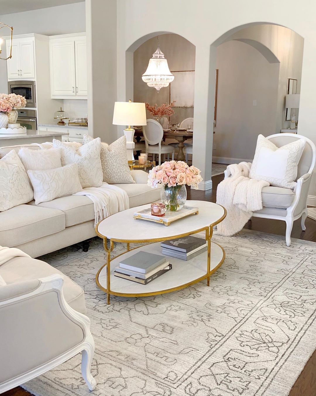 Glam Living Room Decor with Fresh Pink Roses and White Oval Coffee Table via @thedecordiet