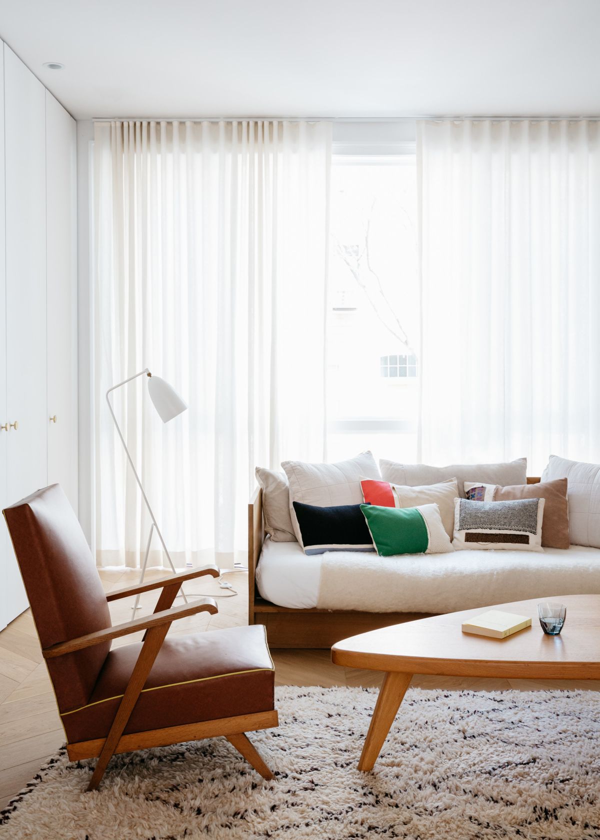 Mid-Century Modern Living Room Decor with Brown Leather Accent Chair via Alexa Hotz