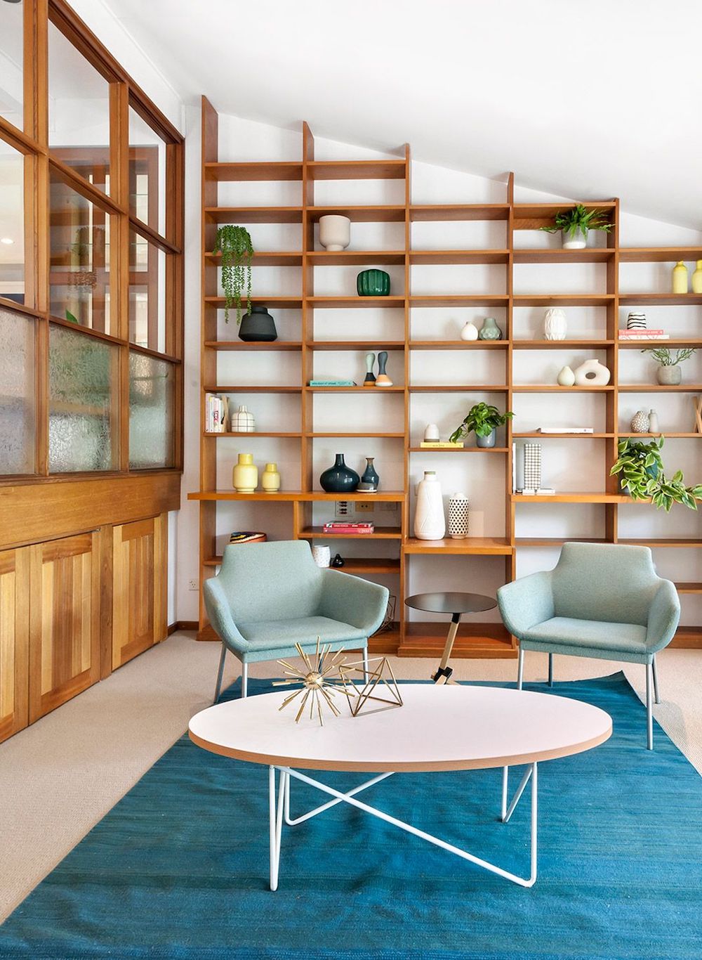 Mid-Century Modern Living Room with Built-in Wood Bookshelves via Pettit and Sevitt