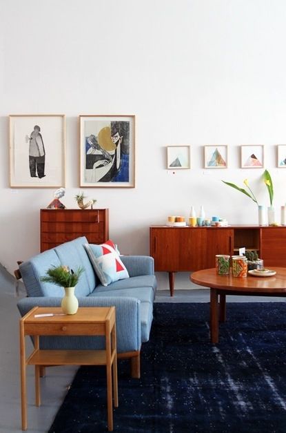 Mid-Century Modern Living Room with Navy Rug and Wood Sideboard