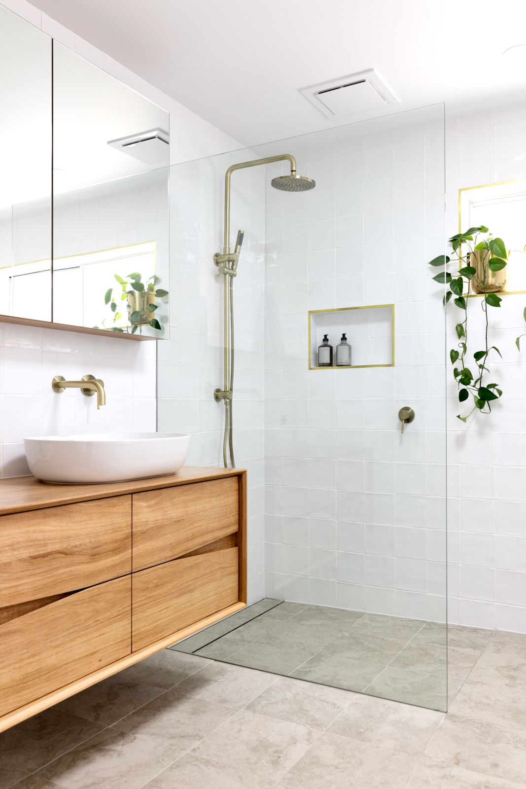 Scandinavian Bathroom with Wood Vanity and House Plants via theinteriorsaddict