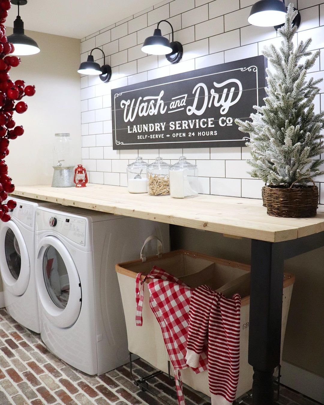 Christmas Laundry Room with Red Clothing in the Laundry Bins via @randilynnblog