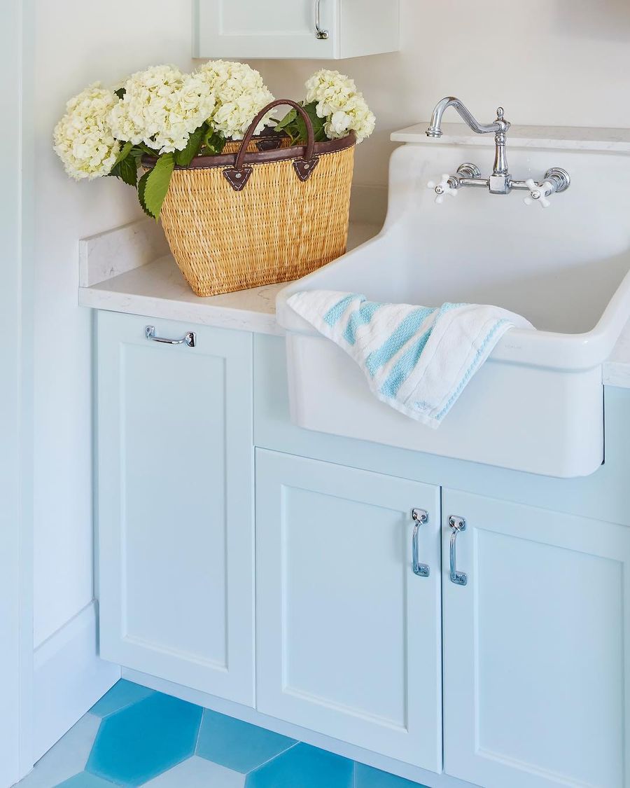 Apron-Front Sink in a Coastal Laundry Room with Blue Tile Floor via @karahebertinteriors