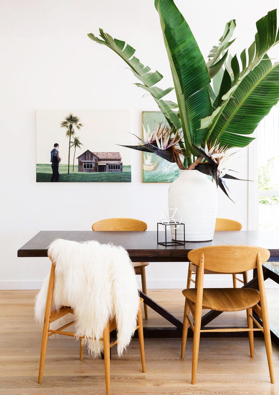 Banana Leaf Centerpiece in Tropical Dining Room with Mid-century dining Chairs