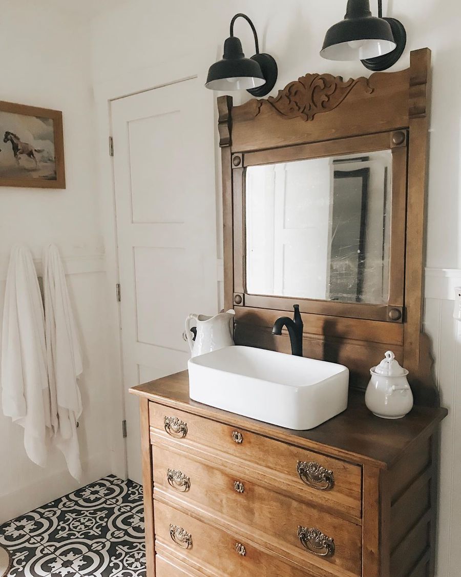 Black-Gooseneck-Wall-Lights-in-Farmhouse-Bathroom-with-Vintage-Dresser-as-Vanity-via-@thewhitelilyfarm