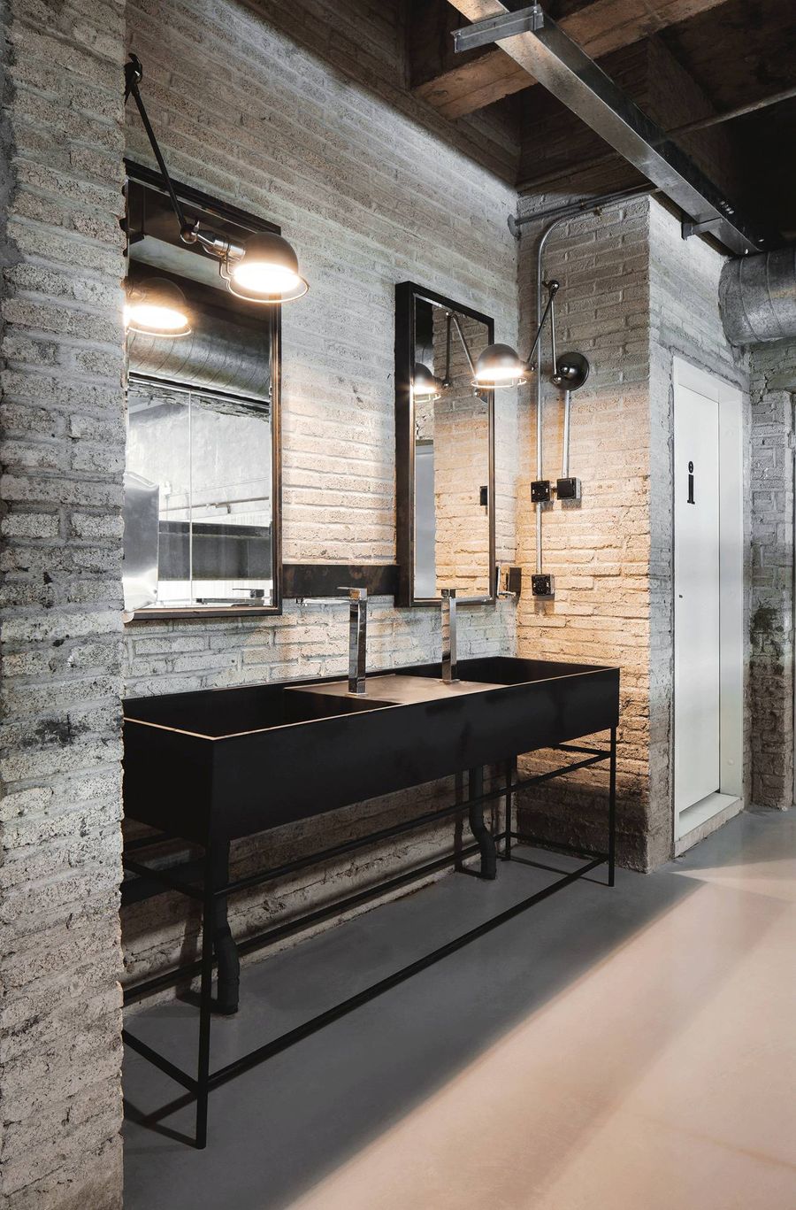 Black Metal Double Vanity In Industrial Bathroom With White Brick Walls Via Jingze LI Of NARRATION 