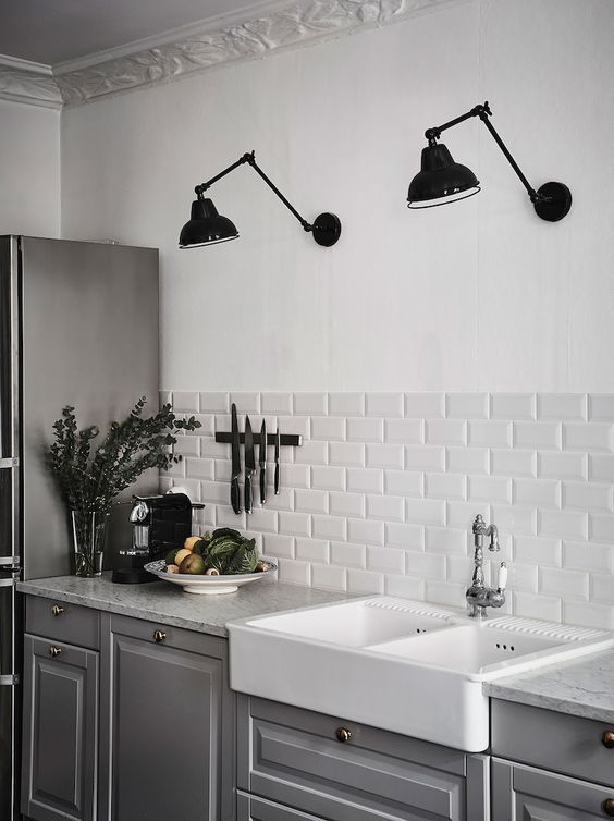 Black Wall Sconces, White Subway Tile, Gray Cabinets in Scandinavian Kitchen Design