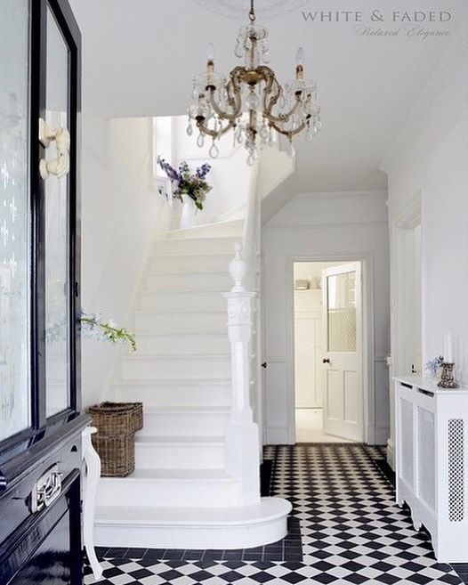 Black and White Checkered Floor Tiles and a Crystal Chandelier in a French Country Entryway via @white_and_faded
