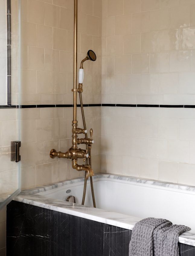 Brass Shower Hardware in Neutral Bathroom via landedinteriors