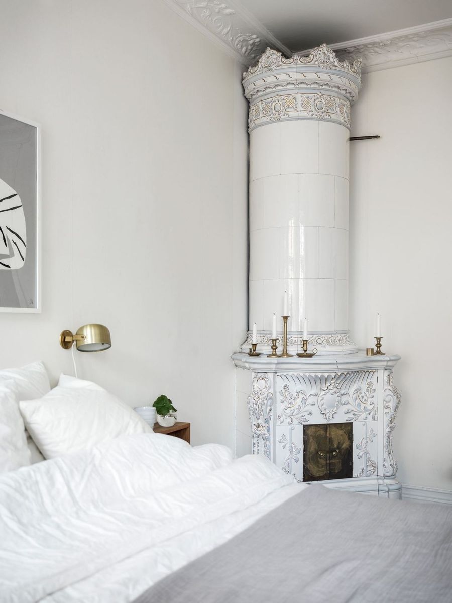 Brass Wall Sconce in a Scandinavian Bedroom via Kvarteret Makleri