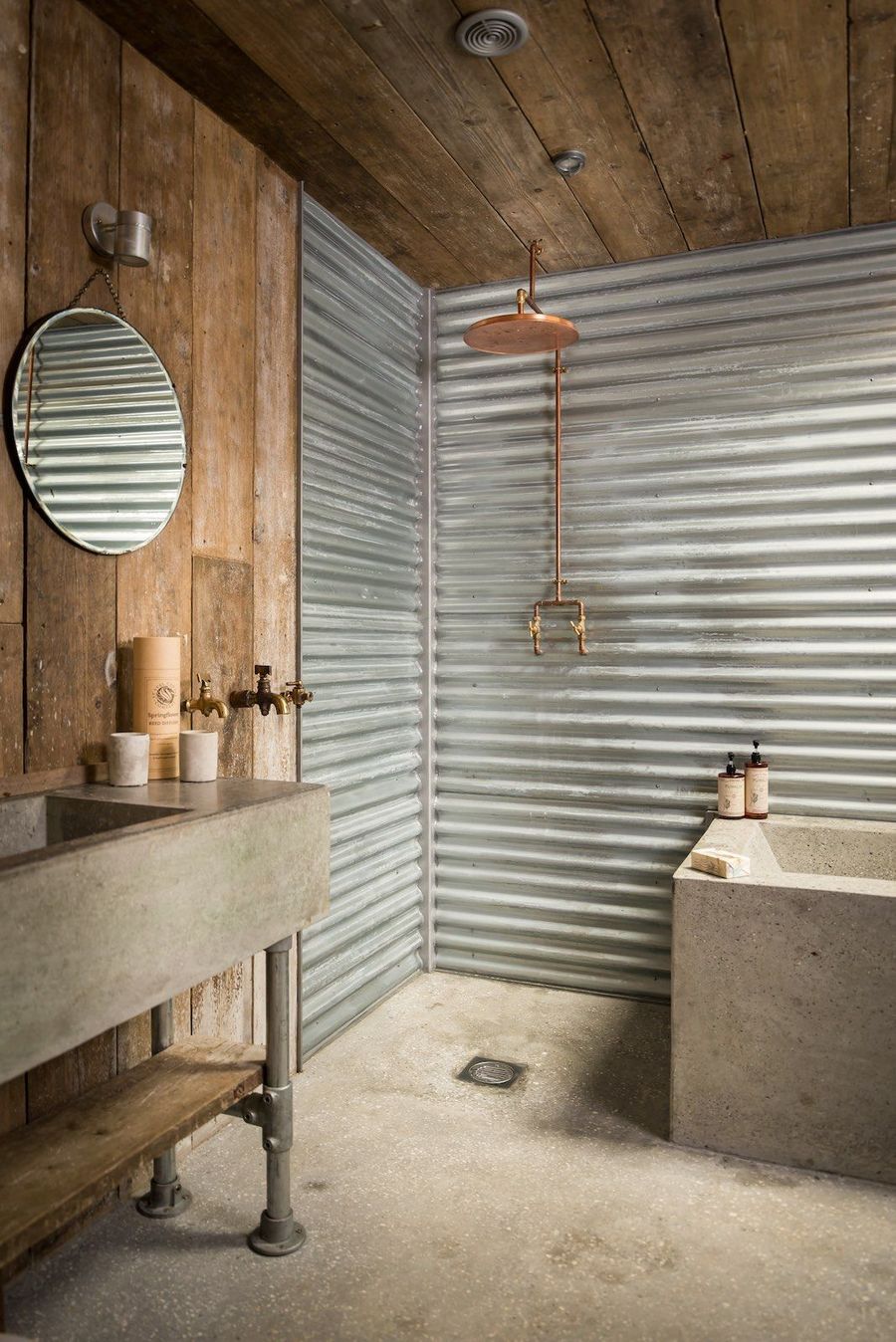Corrugated steel walls and concrete vanity with metal legs via Unique Home Stays