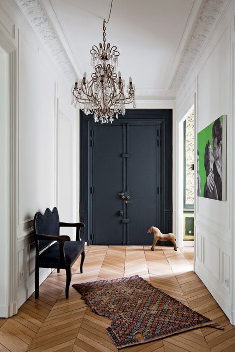 Crystal Chandelier in Parisian entryway design with black front door