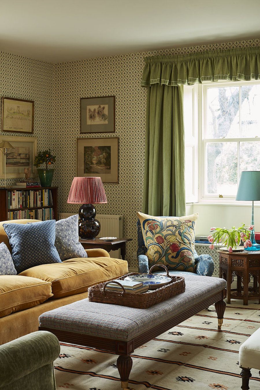 English Country Living Room with Plush Seating and Patterned Wallpaper via Rita Konig