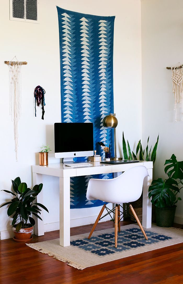 Exotic textiles hanging on wall in Bohemian Office Decor via Chy Parker