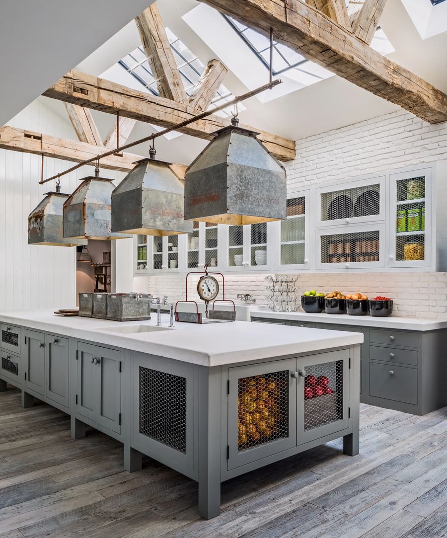 Galvanized Pendant Lights and Wood Ceiling Beams in Country Kitchen via Architectural Digest
