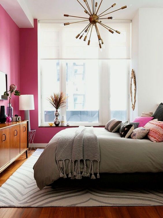 Gold Starburst Chandelier in Mid-Century Modern Bedroom with Pink Walls