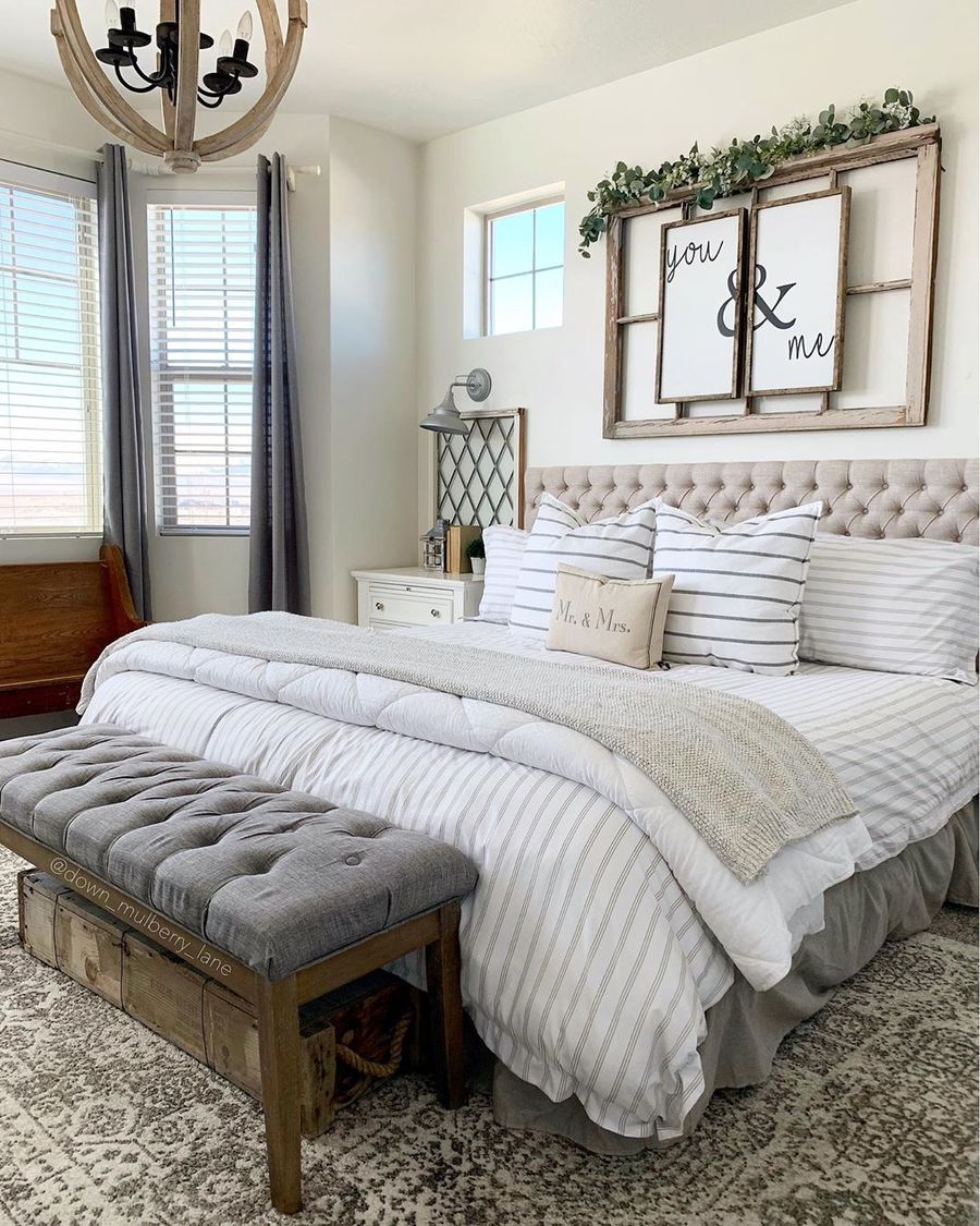 A Gorgeous Farmhouse Bedroom With An Upholstered Bed And Bench, With ...