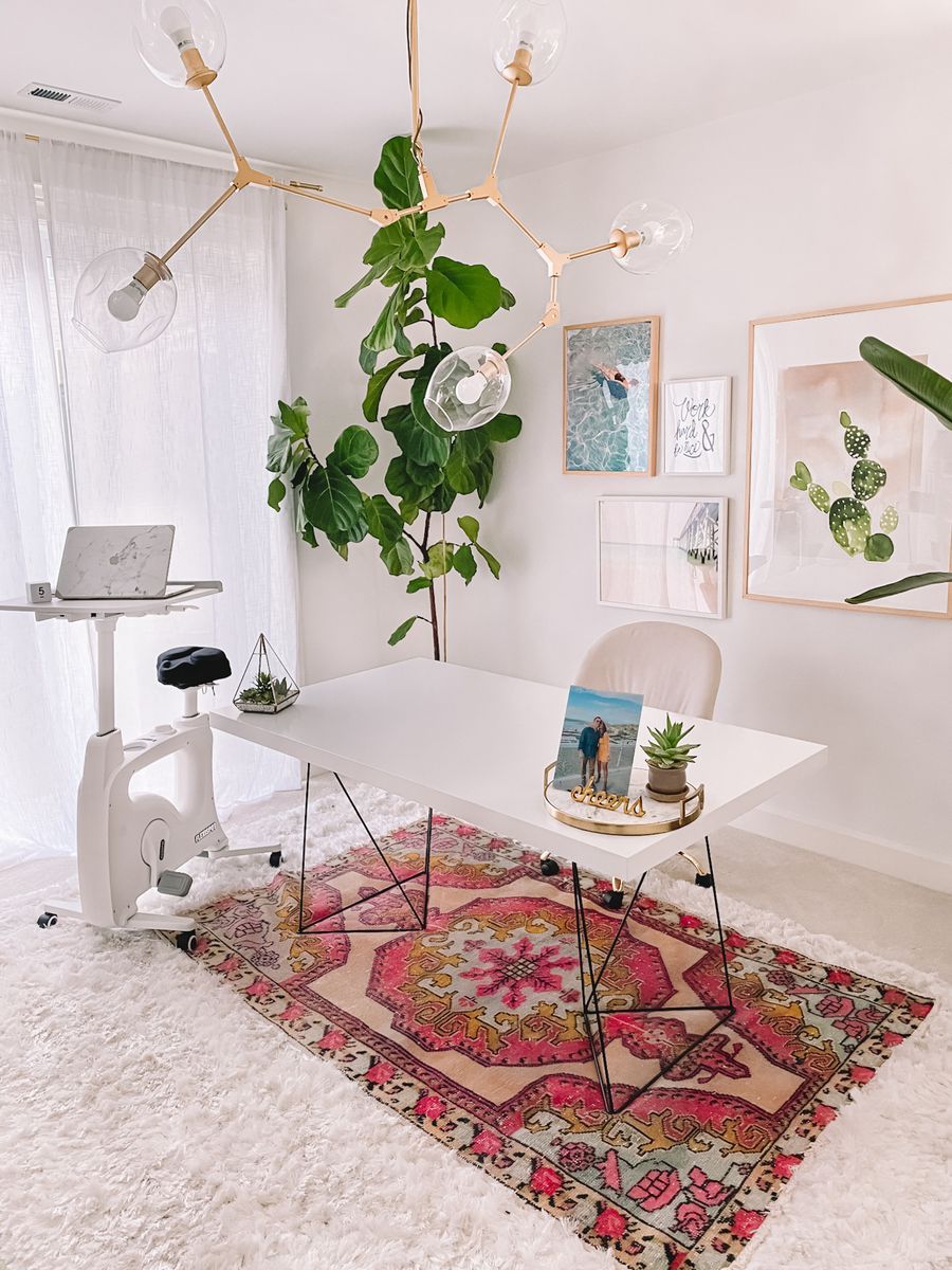 Minimalist white desk in Bohemian Office Decor with fiddle leaf fig, mid-century gold pendant light, boho photography and pink oriental rug via gypsy tan