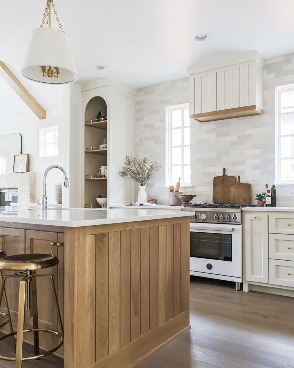 Neutral Kitchen Decor with Brass Bar Stools and Wood Paneled Kitchen Island via @kelseyleighdesignco
