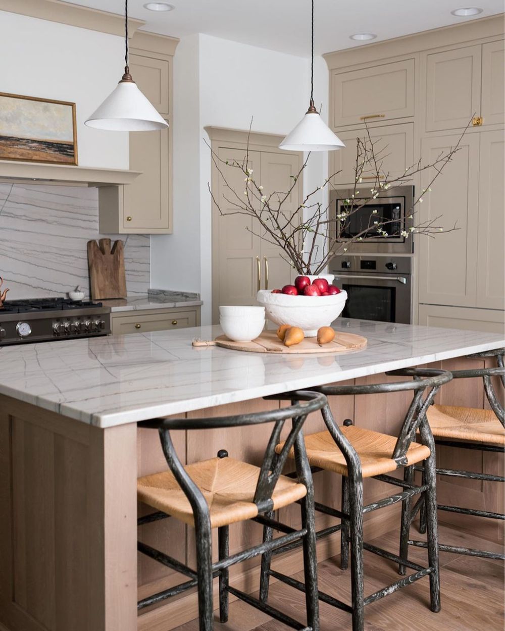 Neutral Kitchen With Treebranch Centerpiece And Wishbone Counter Chairs And Beige Cabinets Via @whittneyparkinson 