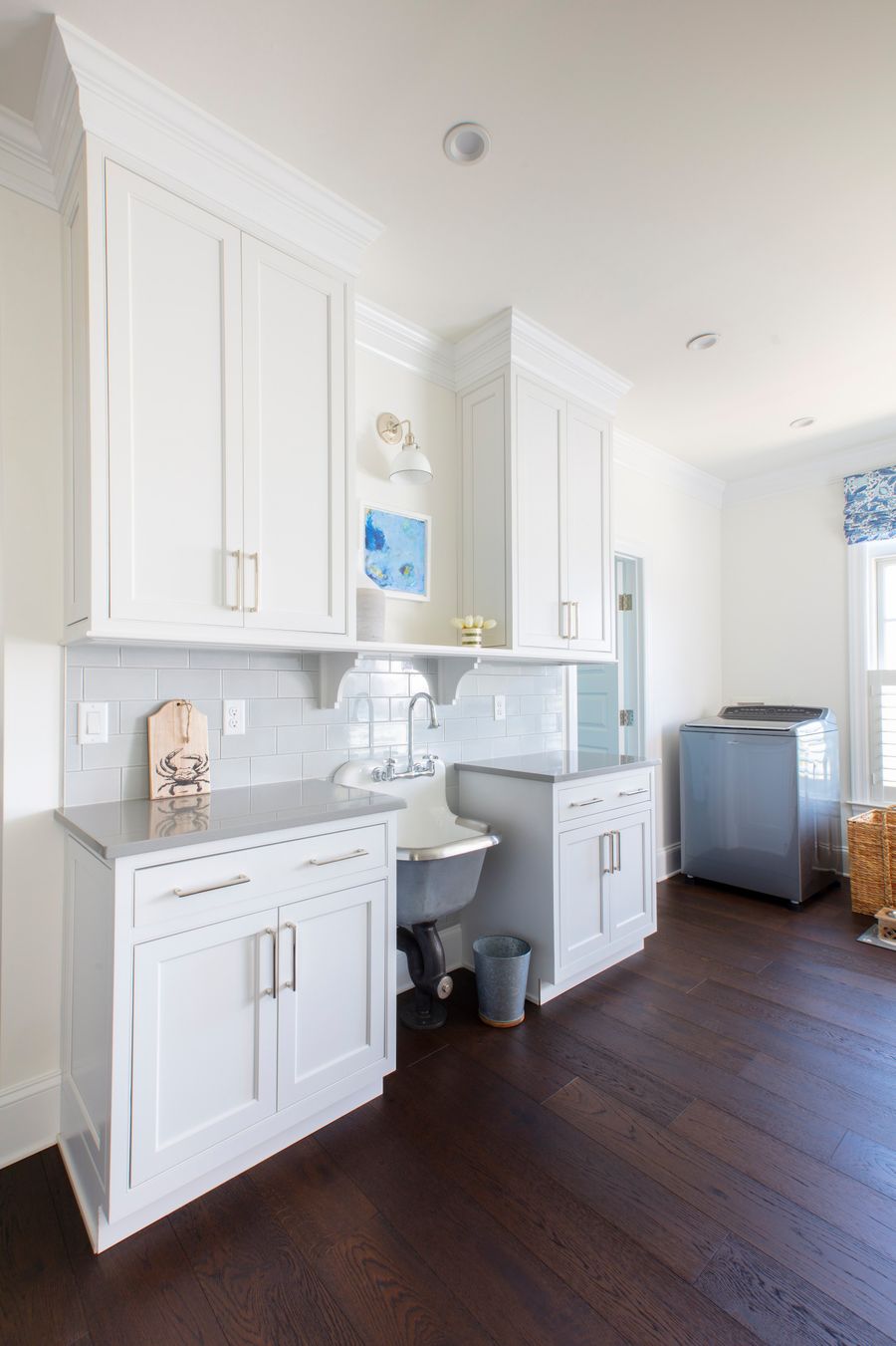 Pale Blue Backsplash in Beach Home Laundry Room via Becker Morgan Group