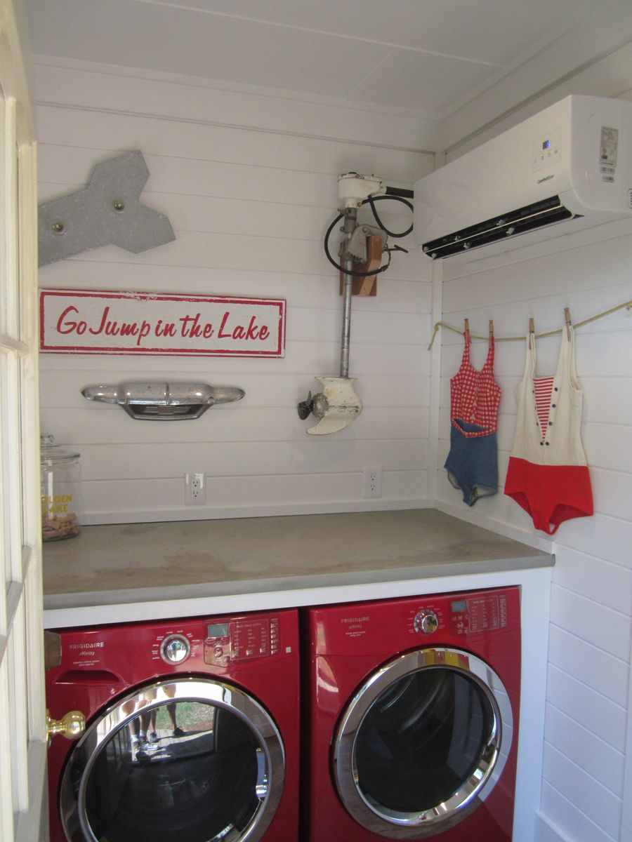 Red washing machines in a lakehouse laundry room via brad2141