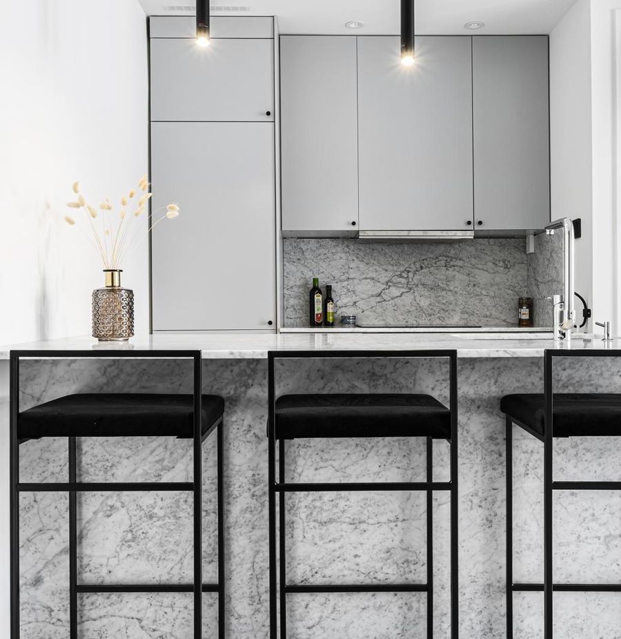 Scandinavian Kitchen with Marble Island and Black Hardware via vaningen.se