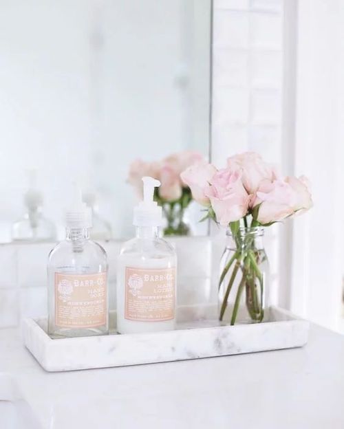 Small Jar of Flowers - Spring Bathroom decor ideas via Caitlin Wilson