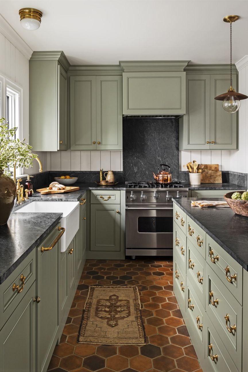 Terracotta Floor Tiles and Sage Green Cabinets in Country Kitchen via Haris Kenjar