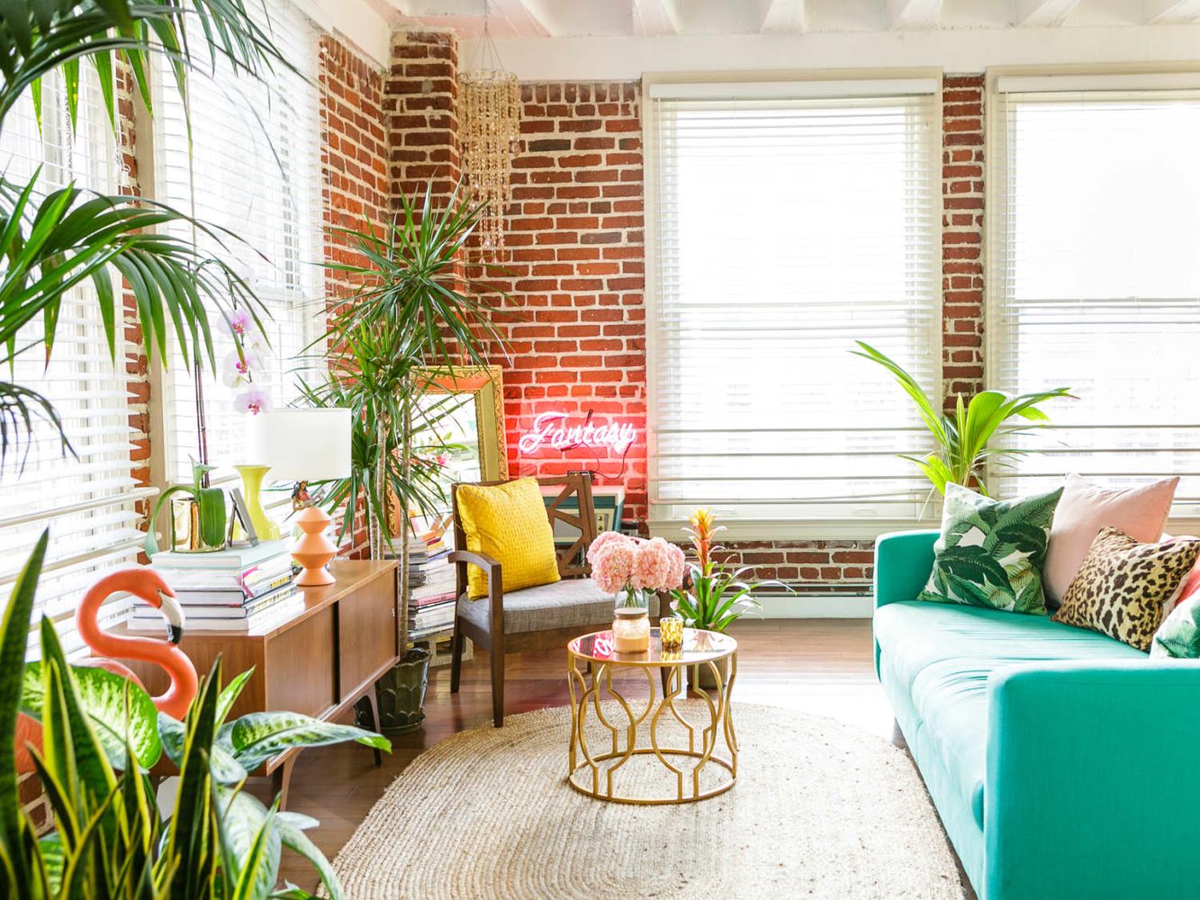 Tropical Living Room with Neon Sign Light and Turquoise Sofa via Rory Rockmore