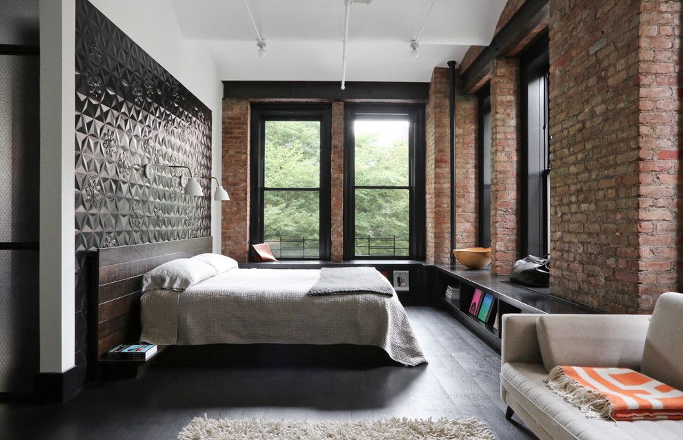 Black Floor and Black Wall Tile Behind Headboard in Industrial Bedroom via Union Studio