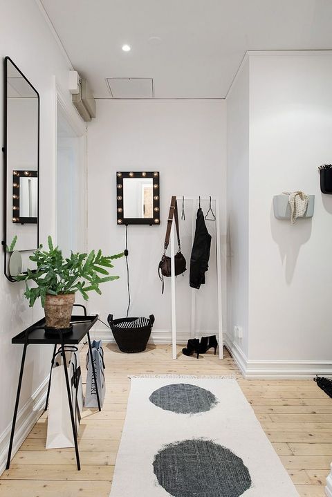 Black and Cream Rug in Scandinavian Entryway Design