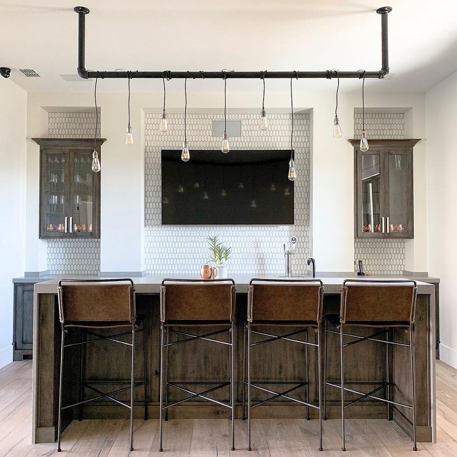 Brown Leather Counter Chairs with metal pipe and bare light bulbs above kitchen island in Industrial Kitchen via @jamilancasterdesign