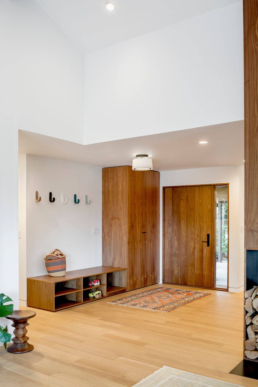 Built-in Armoire and Shoe Storage Bench in mid-century modern entryway design by risa boyer architecture