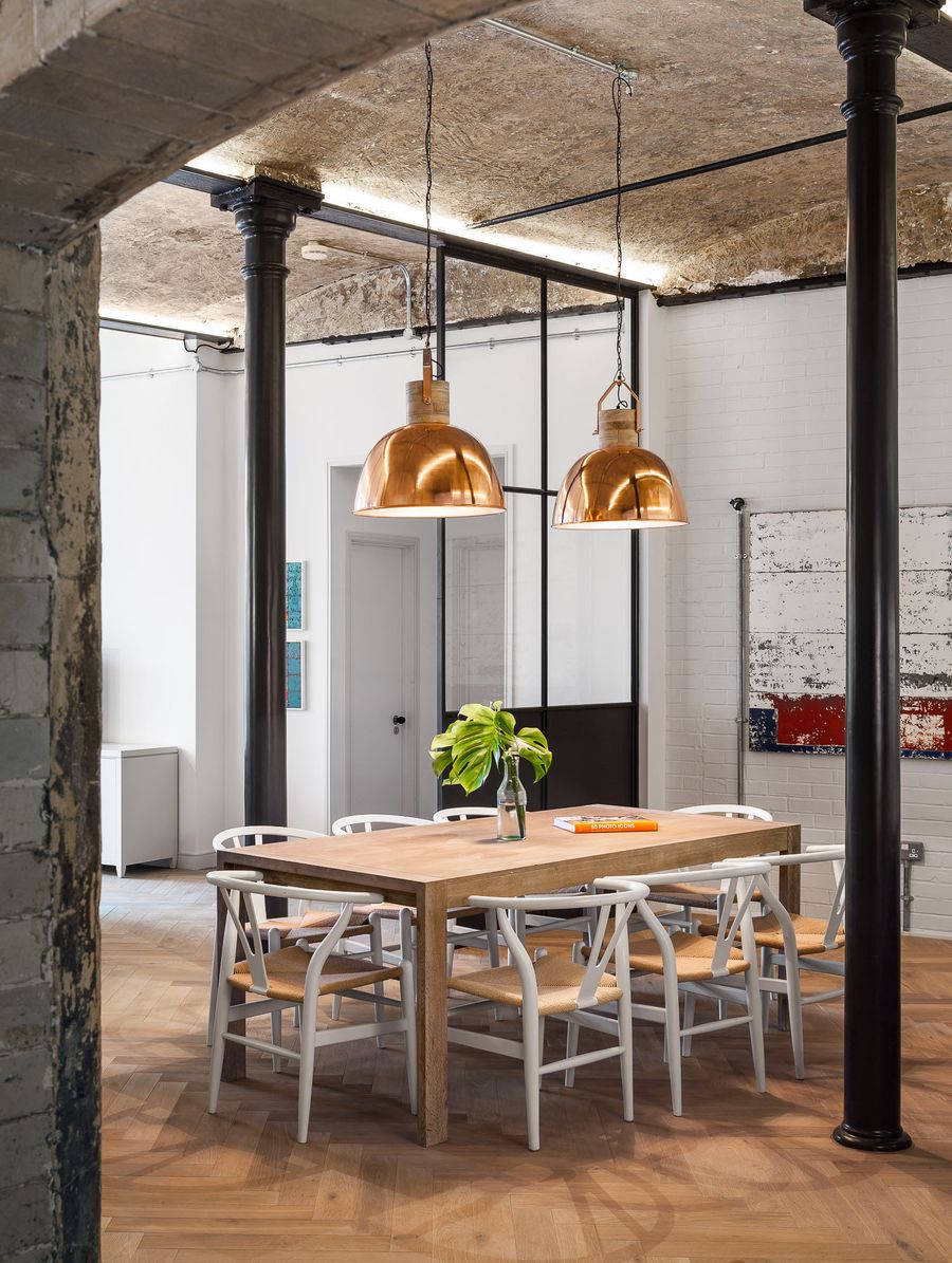 Copper Dome Pendant Lights above Industrial Dining Room Table via Jo Cowen Architects