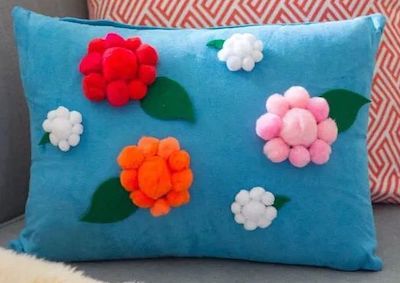DIY Pom Pom Flower Pillow for Spring Home Decor via designimprovised