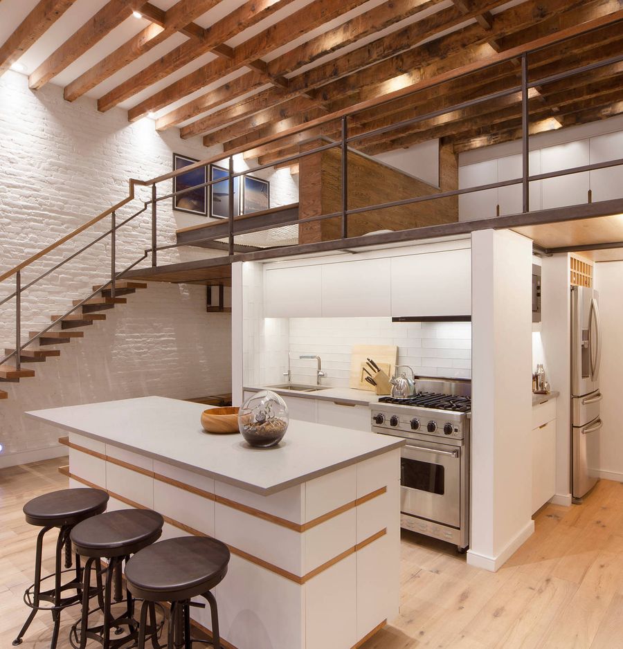 Exposed Wood Ceiling Beams and Painted White Brick Wall, three bar stools, mezzanine in Industrial Kitchen via 2nyad