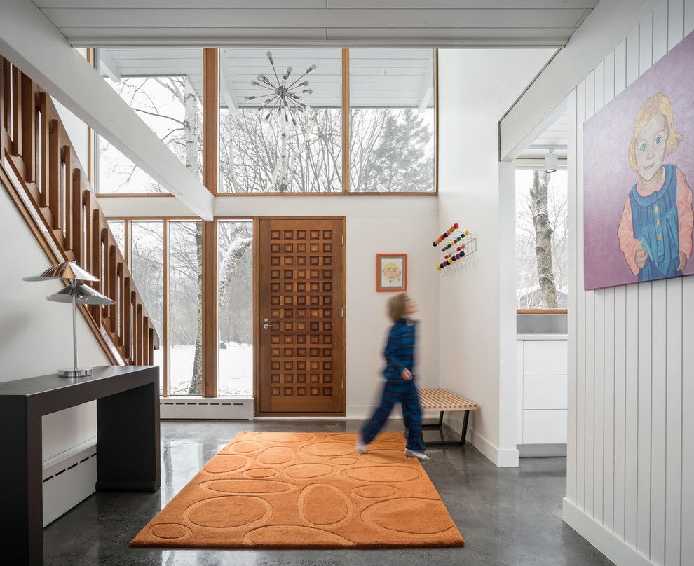 High Ceilings in Mid-Century Modern Entryway Design via woodhullofmaine