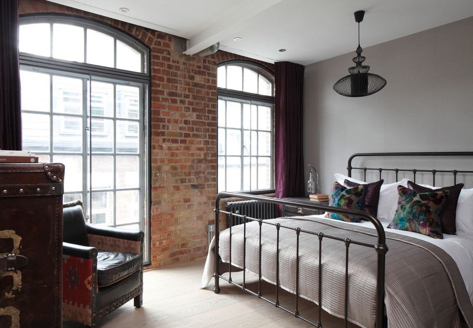 Iron Bed in Industrial Bedroom Decor via Oliver Burns