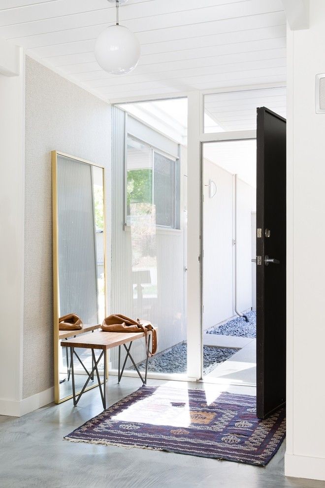 Leaning Wall Mirror in Mid-century Modern Entryway via LMB Interiors