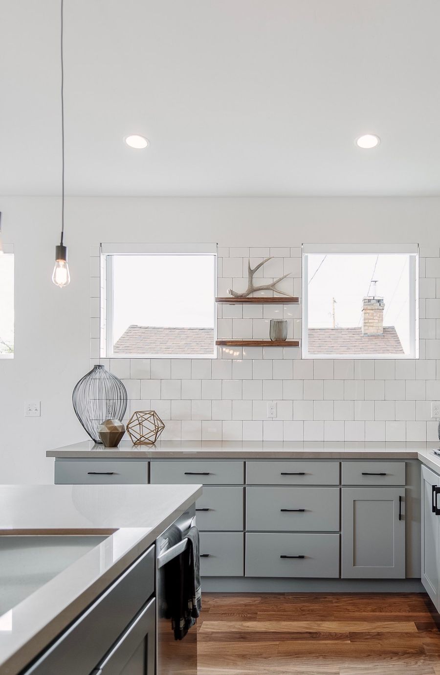 Metal Decor Accents and Bare Bulb Lighting in Industrial Kitchen via Mikelle Mabey