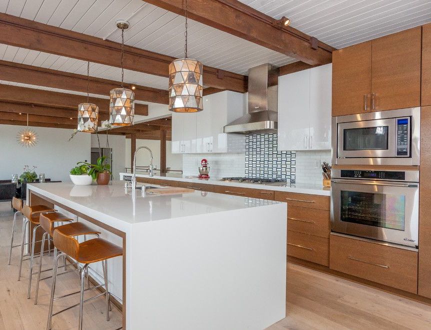 Minimalist White Kitchen Island in Mid-Century Modern Kitchen design by Anthology Interiors