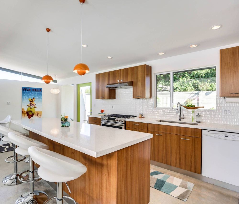 Orange Pendant Lights Mid-Century Modern Kitchen via Moderne Builders