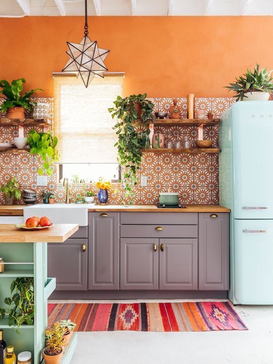 Orange Accent Wall With Floral Boho Backsplash Tiles And Blue Fridge Via The Junglalow 