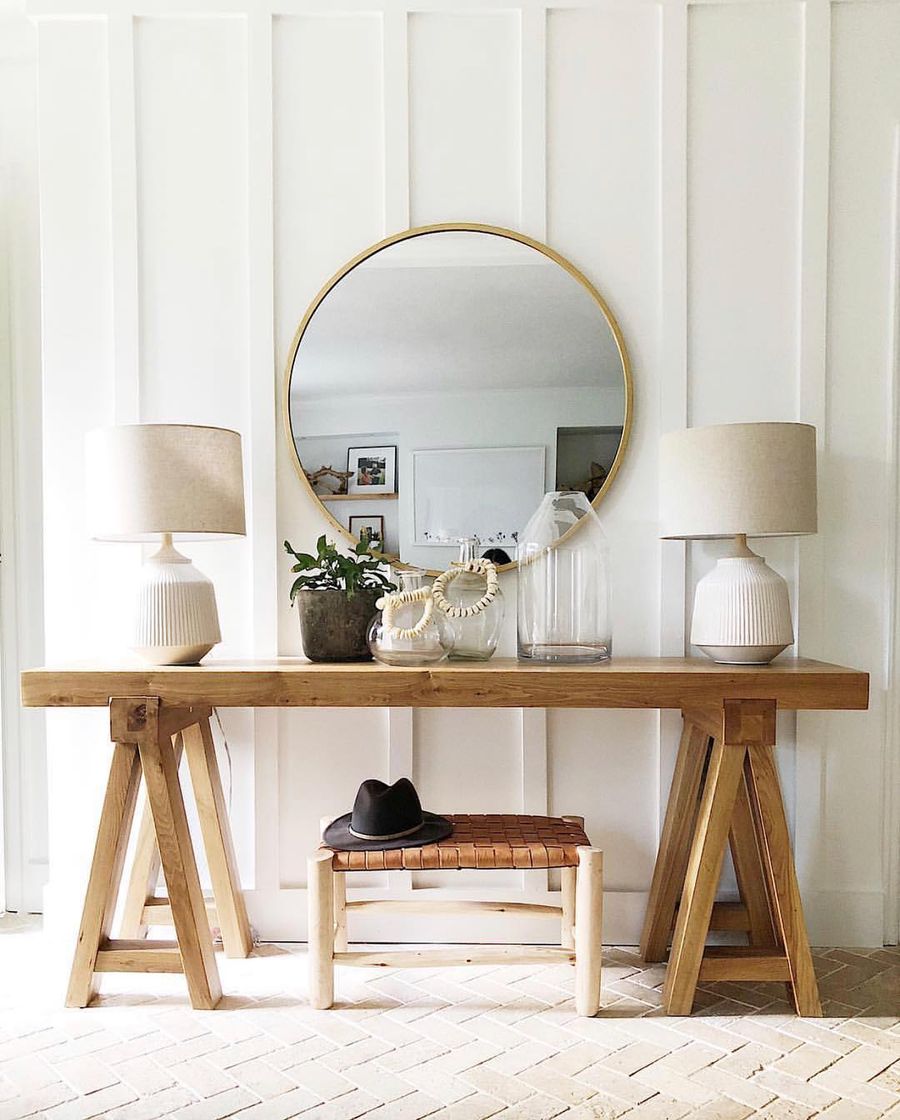 Round Brass Mirror in Neutral Entryway via House Seven Design