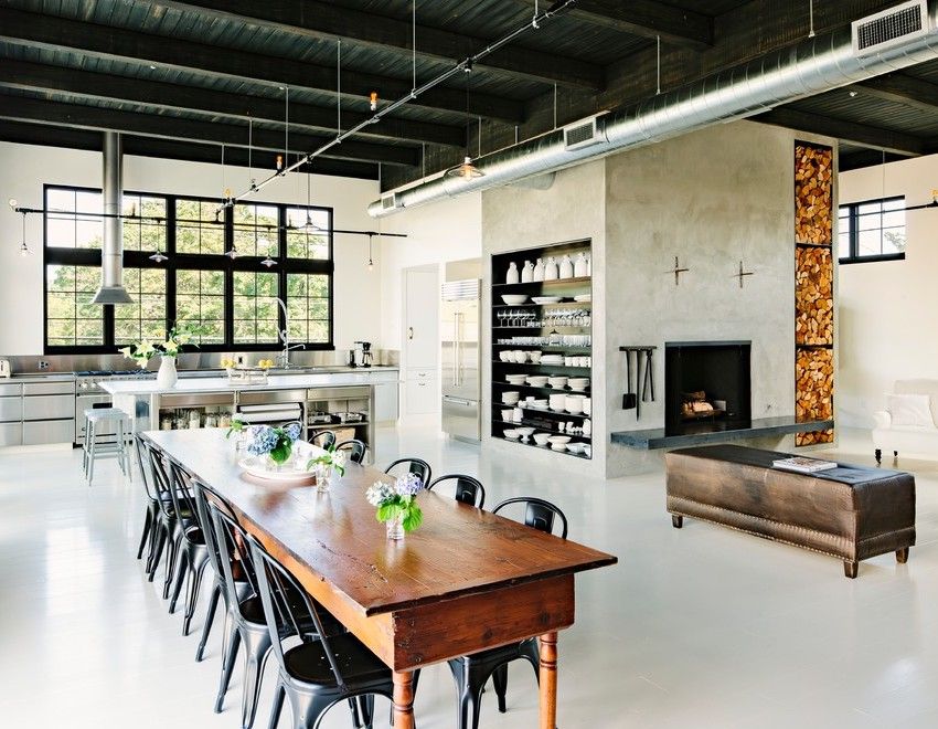 Rustic Dining Table in Industrial Dining Room via Emerick Architects