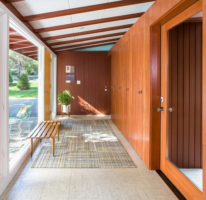 Simple Wood Bench and Built-in Wood Closets in Mid-century Modern Entryway via PKArchitecture