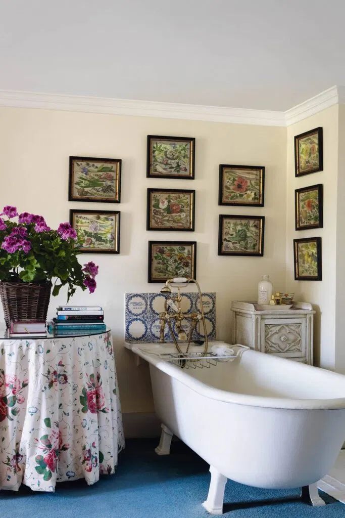 Skirted Side Table near Clawfoot bathtub in English country bathroom design ideas via Holker Estate