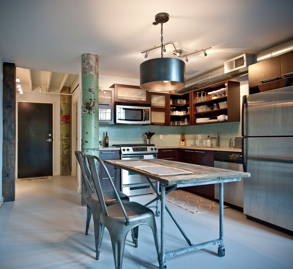 Tolix Chairs in Industrial Kitchen via Heirloom Design Build